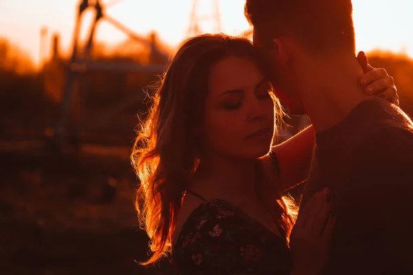 在夕阳背景下的田野里的男人和女孩 — 图库照片