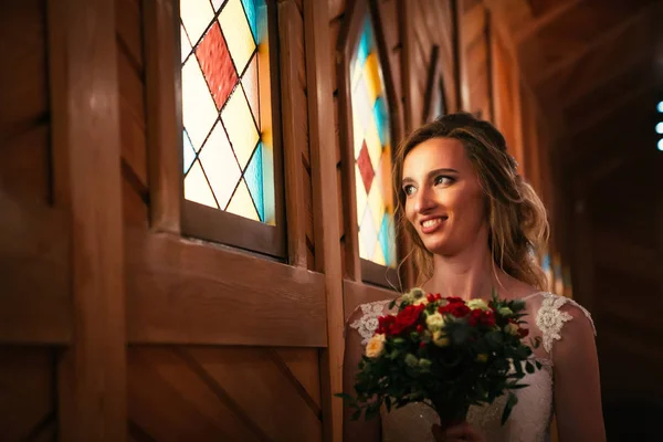 Portrait young beauty bride near the window.