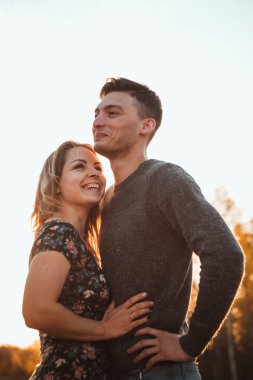 adam ve kız günbatımı arka plan alanında.