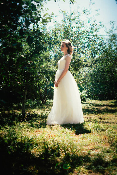 Beautiful young bride in the garden background.