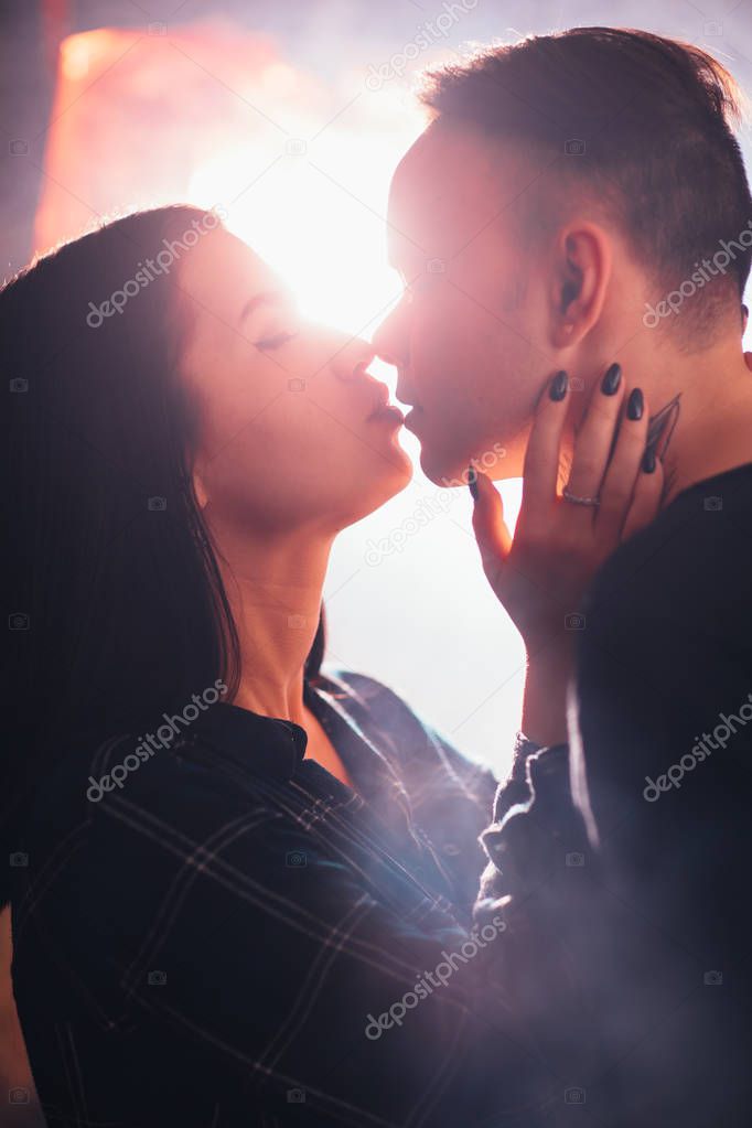 guy and the girl kiss closeup on a light background