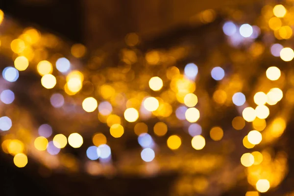 Gold and silver bokeh on a dark background — Stock Photo, Image