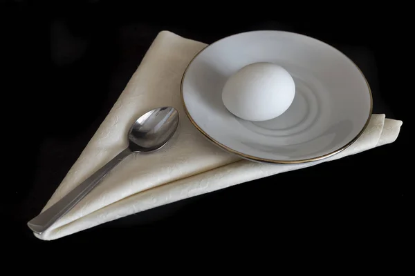 Napkin Saucer Lies Boiled Egg Next Spoon Presented Black Background — Stock Photo, Image