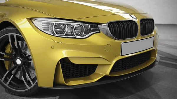 A fragment of a modern yellow car in the garage. 3D rendering. Facade.