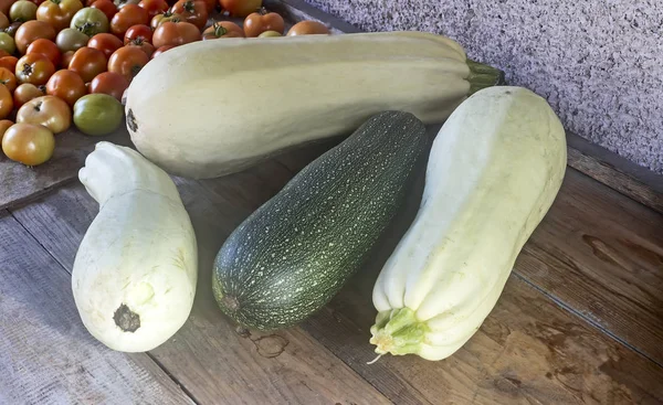 Calabacín y tomates sobre una mesa de madera . —  Fotos de Stock