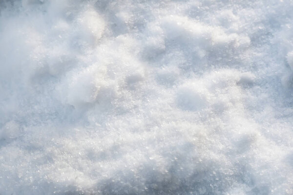 Snow cover with texture of snowflakes and ice crystals. Background image, close-up.