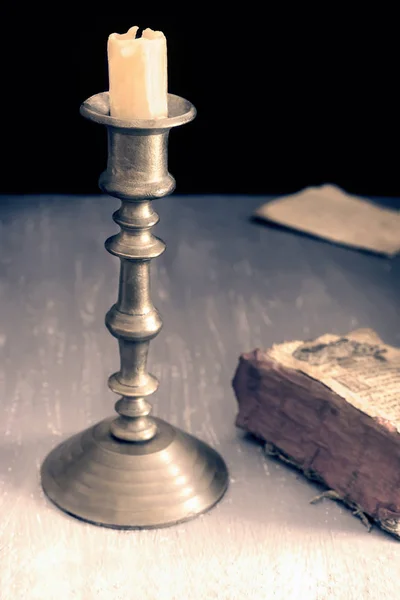 Vintage candle holder and an old book — Stock Photo, Image