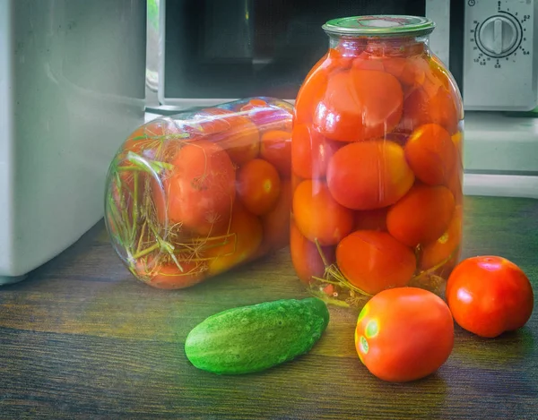 Canned ripe tomatoes in large glass jars. — Stock Photo, Image