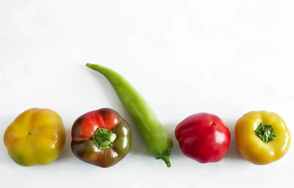 Five Bulgarian peppers on a light background. — Stock Photo, Image