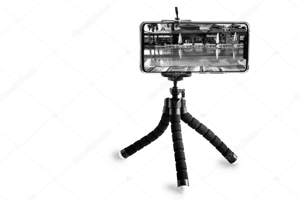 Smartphone and smartphone tripod on white background.