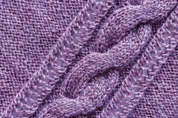 Openwork pattern knitted with needles from pink wool yarn. — Stock Photo, Image