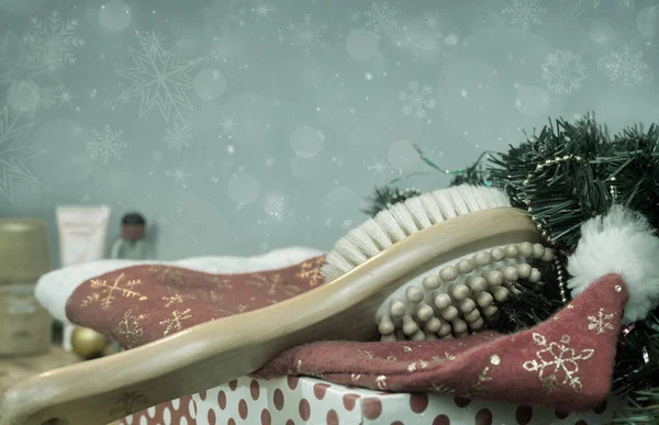 Massage brush and Christmas decorations on wooden background. — Stock Photo, Image