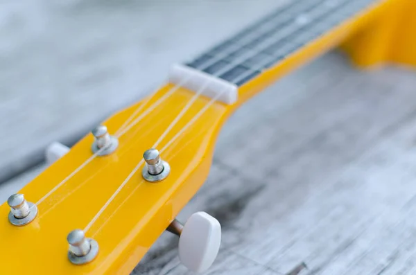 Guitar Neck Yellow Color Fith Blure Effect Gray Table Alone — Stock Photo, Image