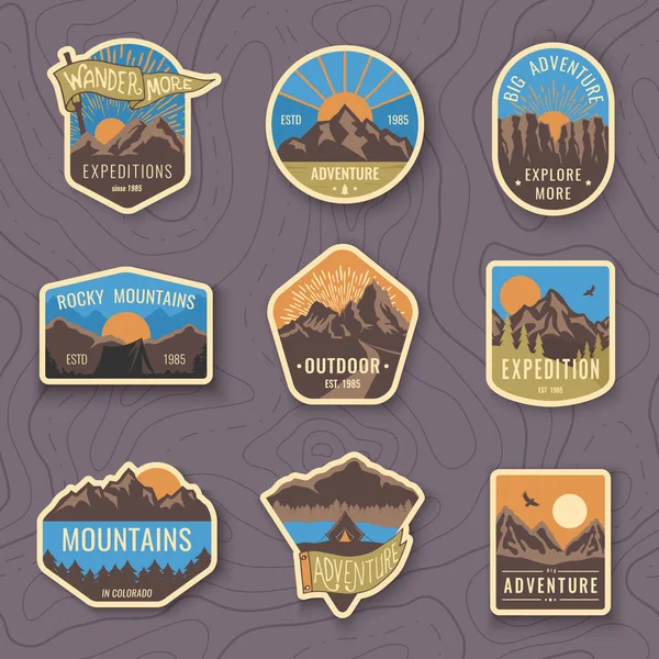 Ensemble de neuf emblèmes de voyage en montagne. Emblèmes d'aventure en plein air camping, badges et patchs logo. Tourisme de montagne, randonnée. étiquettes de camp forestier dans le style vintage — Image vectorielle