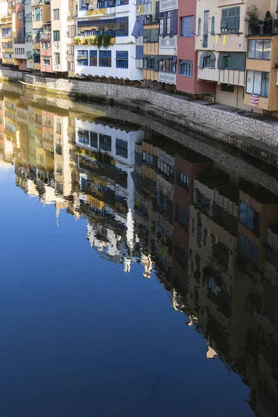 Girona's famous river houses landmarks on a blue sunny day and quiet river waters