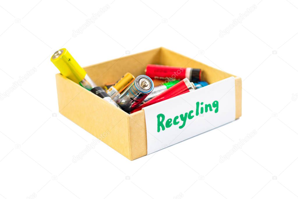 Used AA batteries in a box are ready for the proper disposal and recycling of substances toxic to the environment and soil on a white background. Processing hazardous and recyclable substances.