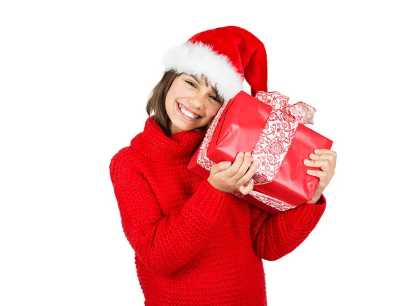 快乐和可爱的小女孩与圣诞老人帽子和红色毛衣拿着红色圣诞礼物 在白色上隔离 — 图库照片