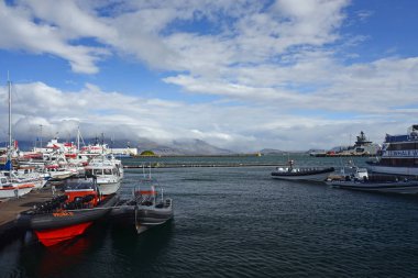 Reykjavik, Iceland, September 20, 2018. Pier for tourist boats in the port of Reykjavik, Iceland against the backdrop of a beautiful landscape. Rubber boat in the foreground.