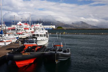 Reykjavik, Iceland, September 20, 2018. Pier for tourist boats in the port of Reykjavik, Iceland against the backdrop of a beautiful landscape. Rubber boat in the foreground.