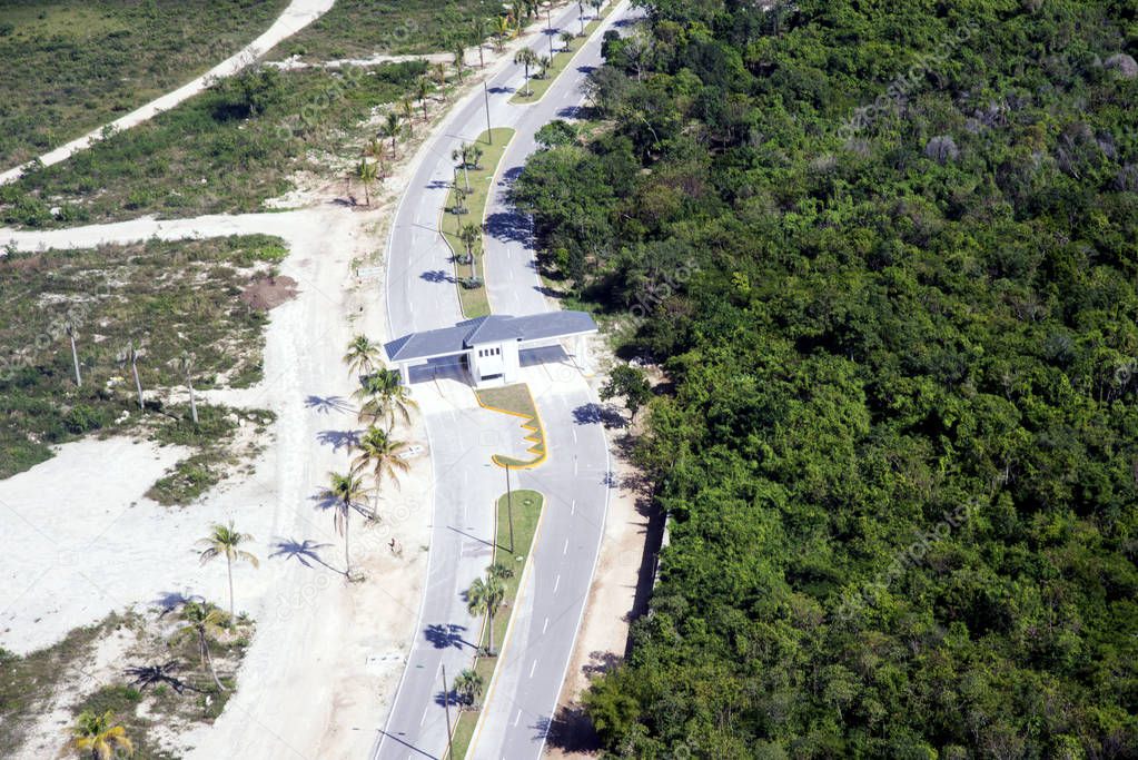 View from above. The road, the checkpoint divides the territory of Punta Cana, the Dominican Republic into two parts: a national park and the coast with sand and palm trees. Contrast.