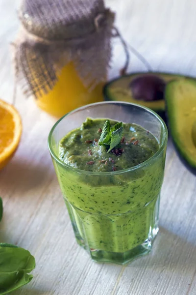 Dahil kalın besleyici smoothies: avokado, elma, muz, ıspanak, portakal suyu, bal, keten tohumu, nane ve zeytin yağı. Doğru beslenme. Sağlıklı yaşam tarzı.