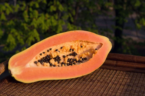 Papaya (Carica papaya) is an exotic, tasty, sweet fruit. Fruit of melon (bread) tree. Papaya seeds are edible and can be a cure. Close-up. — Stock Photo, Image