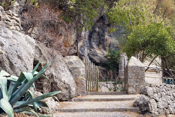 Lépcsők, az út és a sziklák mellett a falak, a csodálatos kolostor Santoire de Luc. A Mallorca szigetén található katolikus kolostor a Baleikus-szigetek spirituális központja. — Stock Fotó