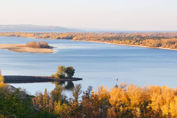 Golden autumn in Ukraine. View of the Dnieper, a small island and yellow trees in the city of Kanev, Ukraine.