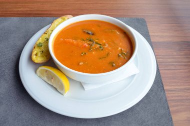 Kızarmış ve biberiyeli, beyaz tabakta balık çorbası. Bir tabak geleneksel Fransız mutfağı..