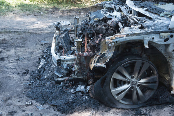 Ukraine, Cherkassy, August 2020. Burned-out car in the courtyard of a residential building. Fire in the car. Danger.