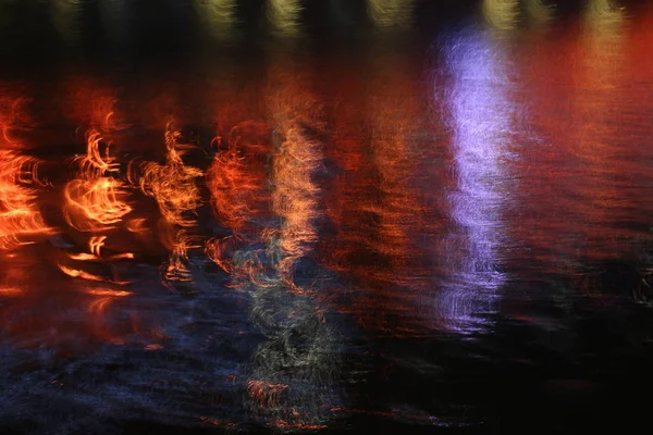 Night river colorful reflection of lights in water