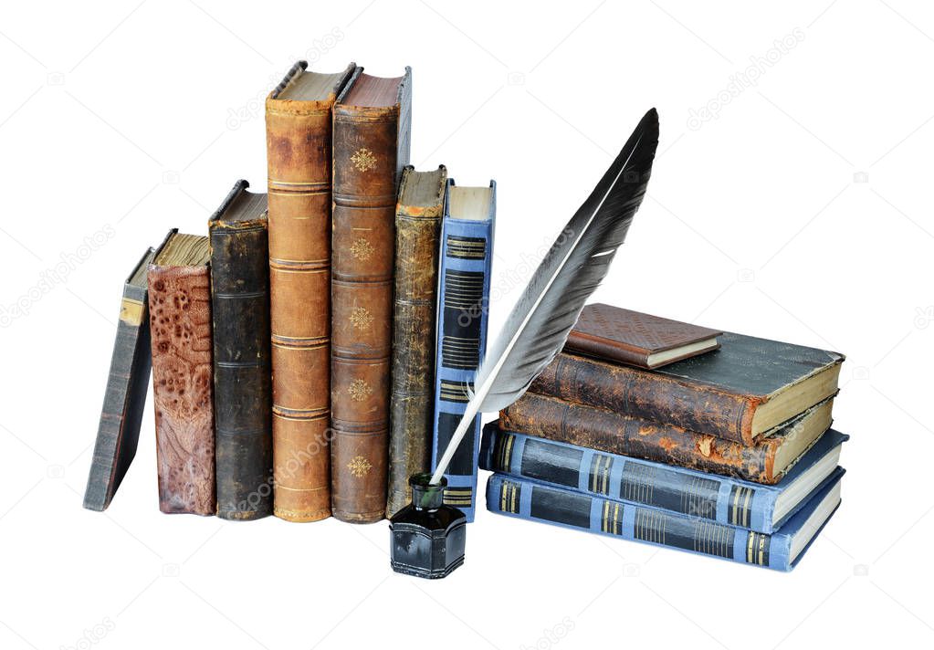 Several old books, quill and the inkwell isolated on a white background