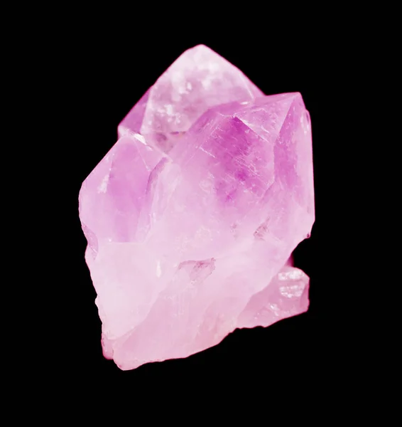 Several crystals of translucent pink quartz isolated on a black background