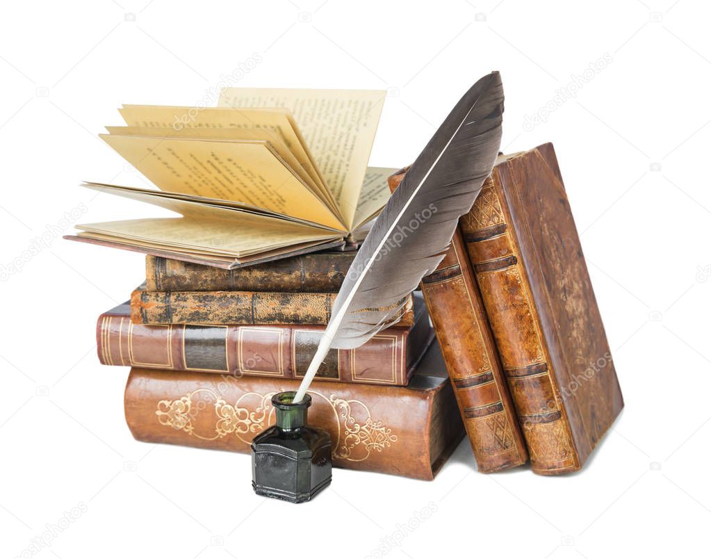 Pile of the old books and a quill in the inkwell isolated on a white background