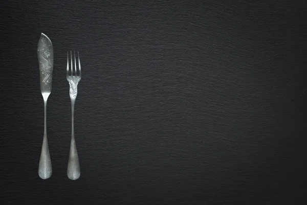 Cutlery for fish on a slate background — Stock Photo, Image