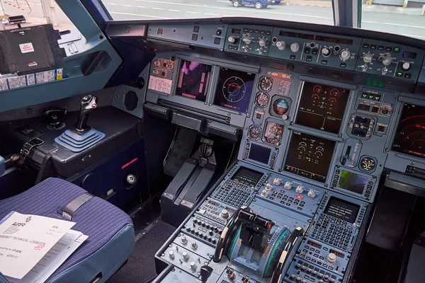 Interior view of pilot cabine in actual modern passenger jet airplane Airbus A319. Many buttons, navigation devices on dashboard. Aviation and transportation.