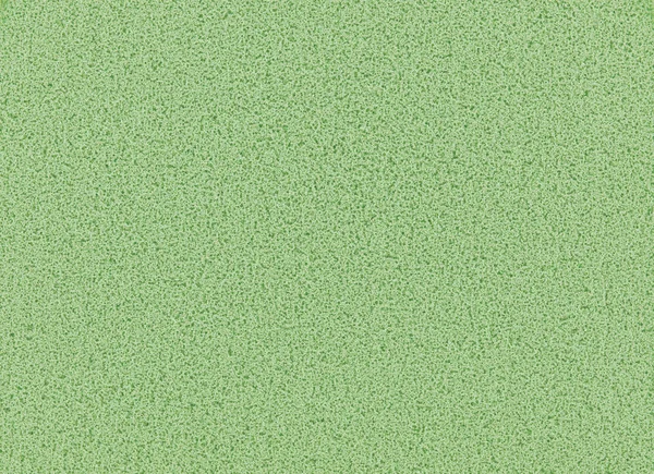 Green sponge texture background, close up view of a cosmetic sponge or pad for facial make up