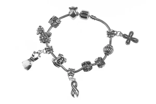 Small silver charm bracelet with many charms isolated on white background