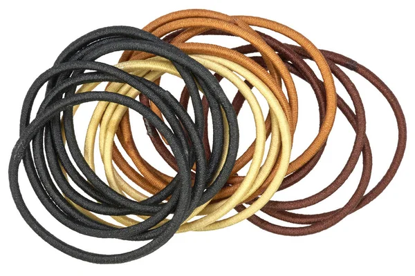 Stack of rubber hair scrunchies and rubber bands, of different colors, isolated on white background