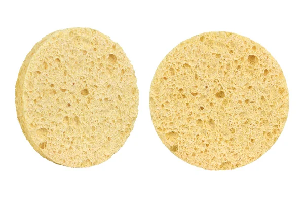 Two beige round cosmetic sponge pads for face make-up cleaning, one frontal and one side view, isolated on white background, clipping path included
