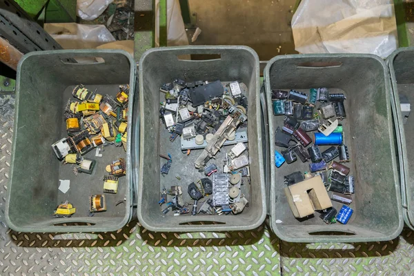 Components of various electronic devices waiting to be recycled on a recycling plant site. Sorted electronic garbage.