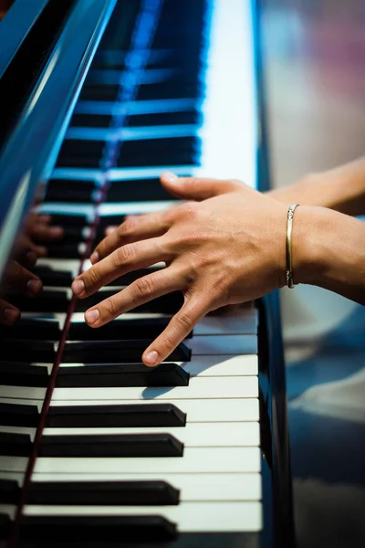 pianist plays on the black piano. hands of a pianist on the background of black and white keys. concert