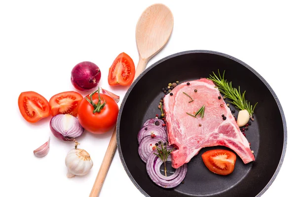 pork on the bone, steak, pieces of pork and vegetables in a pan. isolate on white background