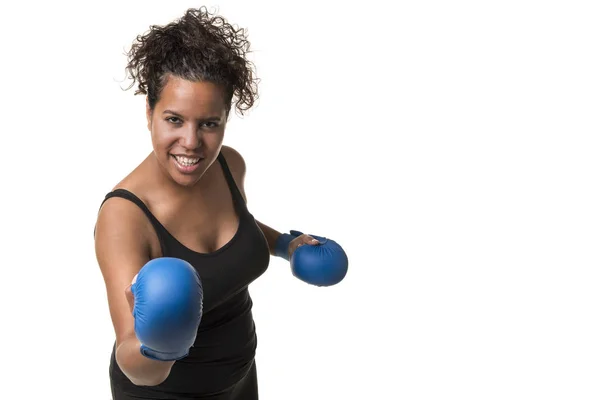 Young pretty black woman with blue boxing gloves working out isolated on a white background