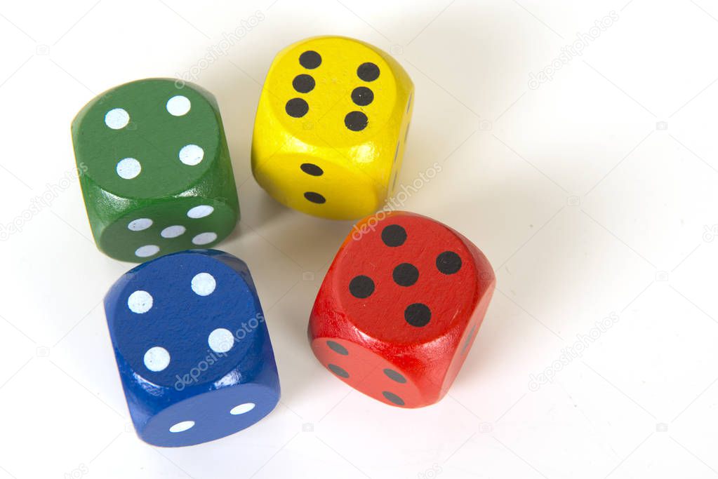 Four colorful gaming dices on a white background background seen from above