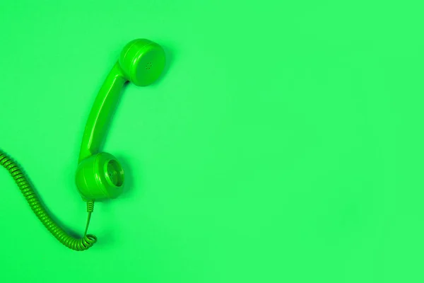 Neon green retro telephone on a green background with copy space — Stock Photo, Image