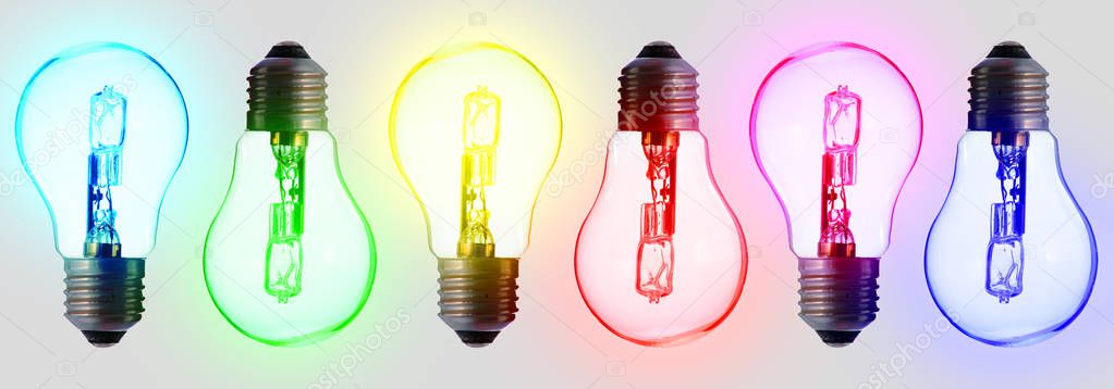 six standard light bulbs; in the color of the rainbow. Aligned on a white background