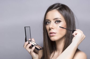 Genç esmer kadın kirpik üzerinde maskara koymak