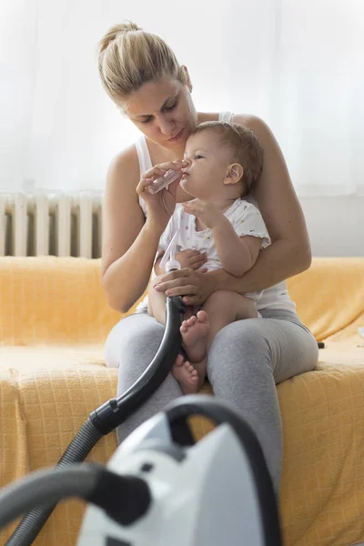 Mother Cleaning Babies Nose Nasal Aspiration Connected Vaccum Cleaner — Stock Photo, Image