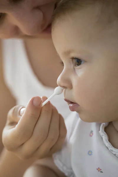 Mother Cleaning Babies Nose Cotton Swabs Stock Picture
